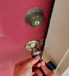 Emergency locksmith opening a door in Boone NC at night